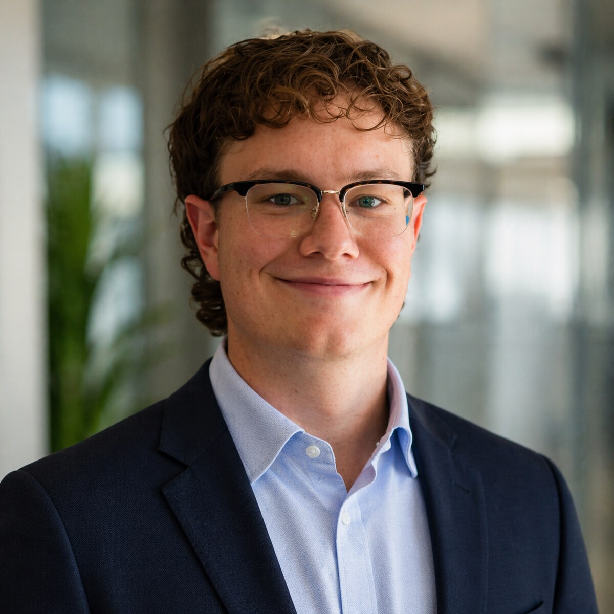 Samuel Kirk wearing a navy blazer and light blue shirt